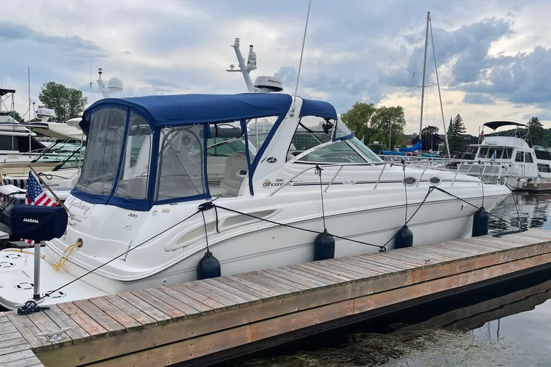 Slide: The Image of 2000 Sea Ray 380 Sundancer yacht docked at marina with blue canopy. - 32