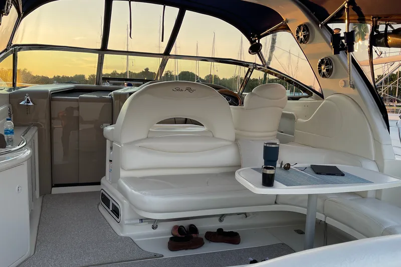 Slide: The Image of Interior of a 2000 Sea Ray 380 Sundancer yacht with elegant seating and table setup. - 8
