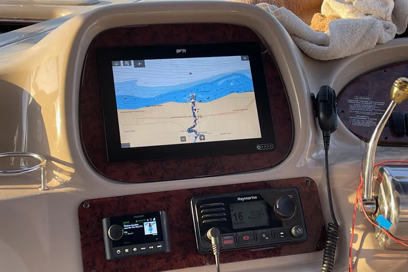 Slide: The Image of Control panel of a 2000 Sea Ray 380 Sundancer with navigation and communication systems. - 11
