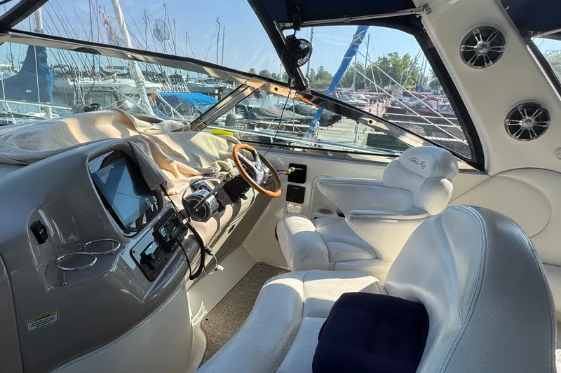 Slide: The Image of Interior of a 2000 Sea Ray 380 Sundancer yacht with plush seating and modern controls. - 9