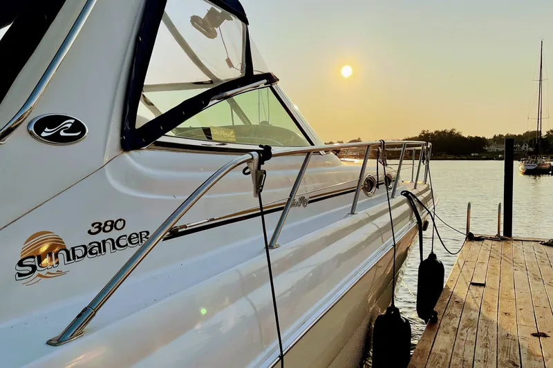 Slide: The Image of 2000 Sea Ray 380 Sundancer yacht docked at sunset, showcasing sleek design and elegance. - 6