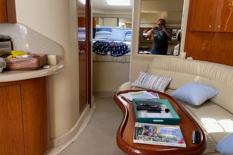 Slide: The Image of Interior of 2000 Sea Ray 380 Sundancer yacht with cozy seating and wooden cabinetry. - 27