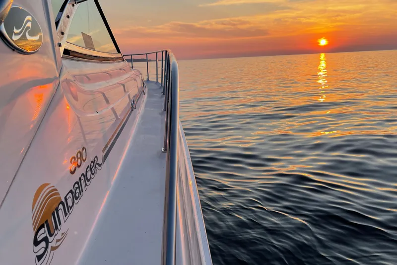 Slide: The Image of Sea Ray 380 Sundancer yacht at sunset on calm ocean waters, 2000 model. - 15
