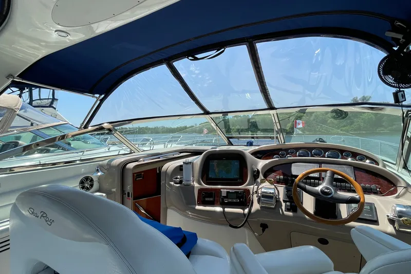Slide: The Image of Cockpit of 2000 Sea Ray 380 Sundancer yacht with steering wheel and navigation equipment. - 26