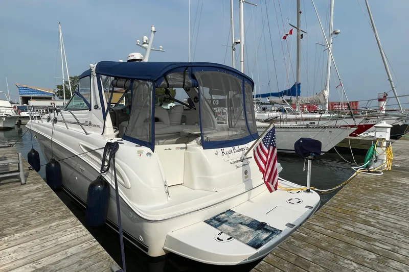 Slide: The Image of 2000 Sea Ray 380 Sundancer docked at marina with American flag displayed. - 35