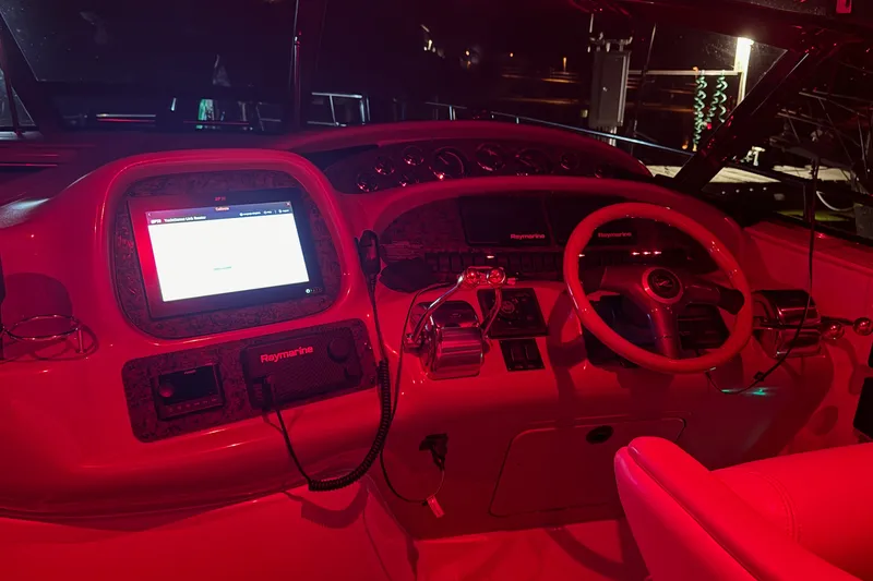 Slide: The Image of Helm of 2000 Sea Ray 380 Sundancer with illuminated controls and Raymarine display. - 40