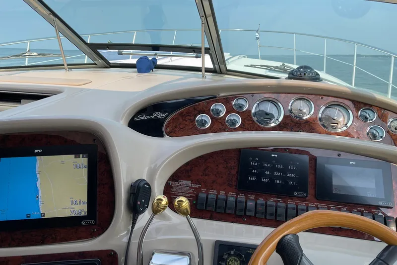 Slide: The Image of Cockpit view of a 2000 Sea Ray 380 Sundancer with navigation instruments and controls. - 14