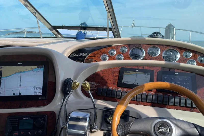 Slide: The Image of Cockpit view of 2000 Sea Ray 380 Sundancer with navigation screens and gauges. - 19