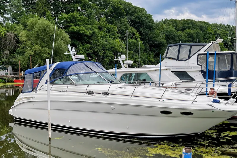 Slide: The Image of 2000 Sea Ray 380 Sundancer yacht docked in a serene marina setting. - 3