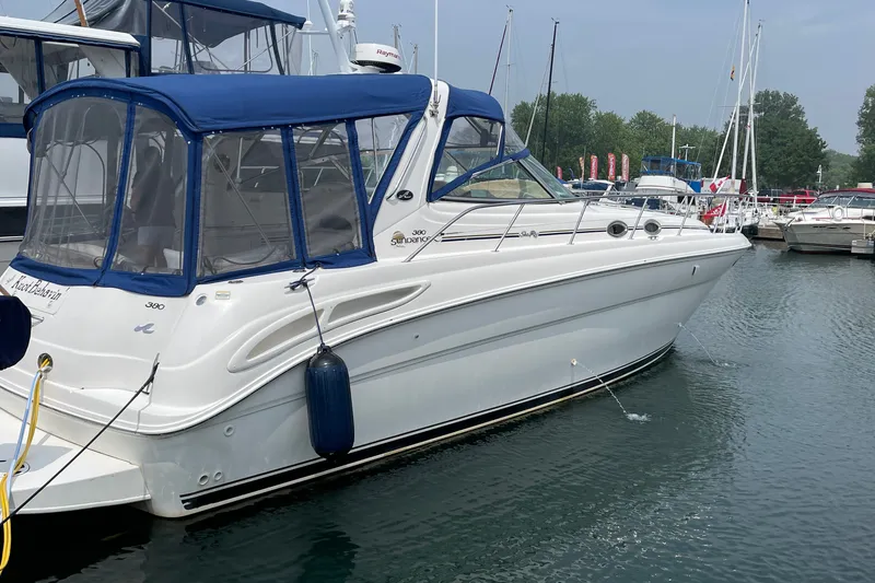 Slide: The Image of Sea Ray 380 Sundancer 2000 yacht docked in marina with blue canopy. - 37
