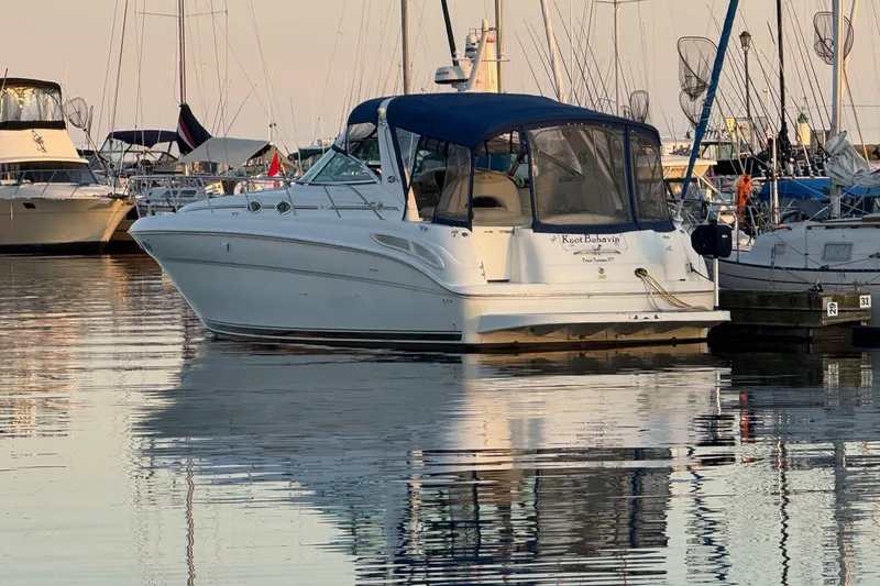 Slide: The Image of Sea Ray 380 Sundancer 2000 yacht docked in a serene marina setting. - 2