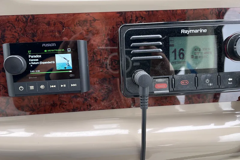 Slide: The Image of Control panel of a 2000 Sea Ray 380 Sundancer with Fusion and Raymarine displays. - 10