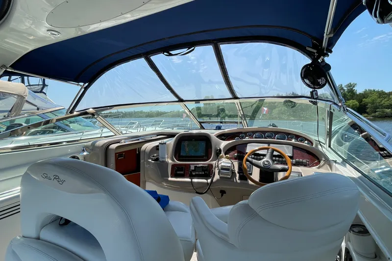 Slide: The Image of Cockpit view of 2000 Sea Ray 380 Sundancer with modern navigation equipment and luxurious seating. - 25