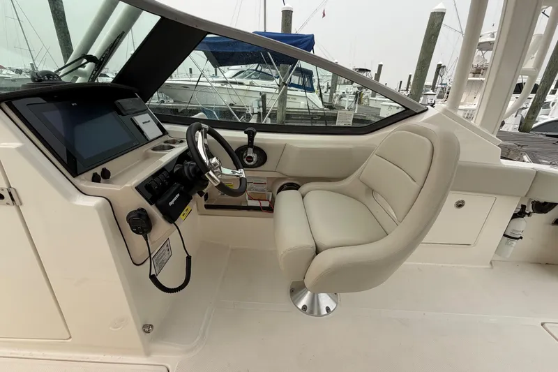 Slide: The Image of 2022 Boston Whaler 240 Vantage helm with modern controls and comfortable seating. - 23