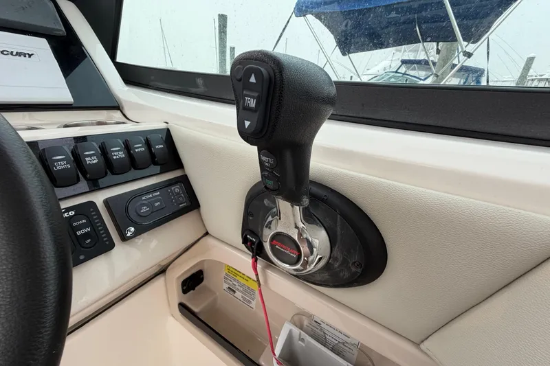 Slide: The Image of Control panel and throttle of 2022 Boston Whaler 240 Vantage boat cockpit. - 28