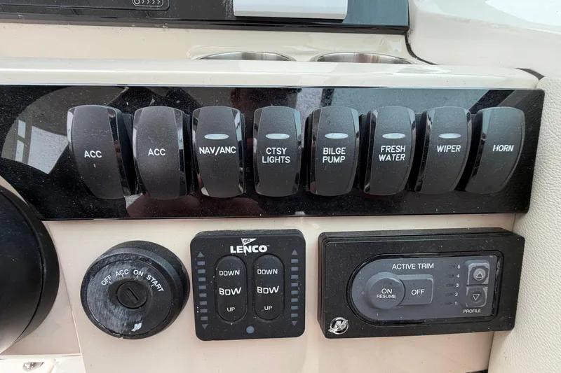 Slide: The Image of Control panel of a 2022 Boston Whaler 240 Vantage boat with various switches and dials. - 29
