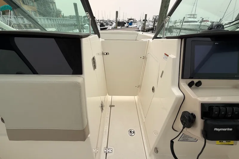 Slide: The Image of 2022 Boston Whaler 240 Vantage boat interior with control panel and seating area. - 20