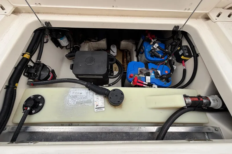 Slide: The Image of 2022 Boston Whaler 240 Vantage engine compartment with batteries and wiring. - 48