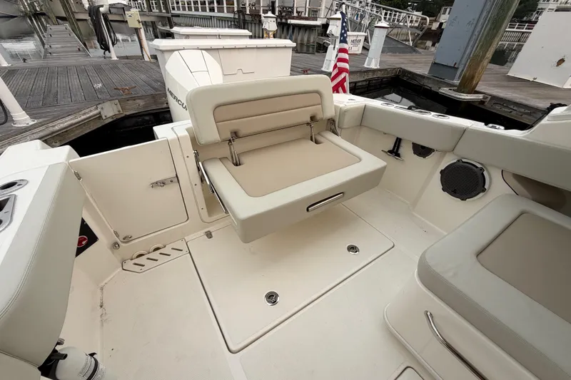 Slide: The Image of 2022 Boston Whaler 240 Vantage boat interior with seating and dock view. - 44