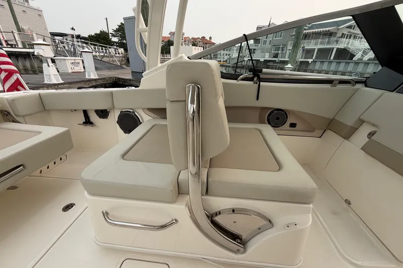 Slide: The Image of 2022 Boston Whaler 240 Vantage boat interior with beige seating and stainless steel accents. - 36