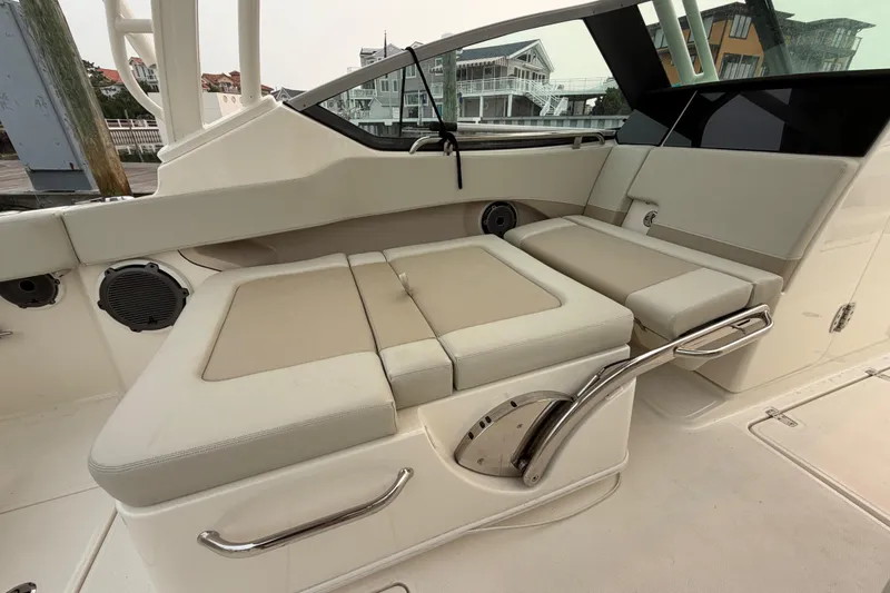 Slide: The Image of 2022 Boston Whaler 240 Vantage boat interior with beige seating and stainless steel accents. - 39