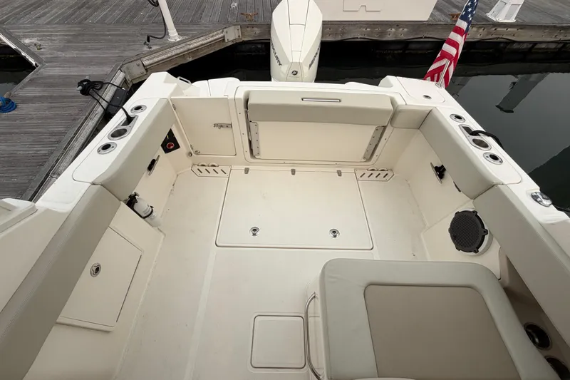 Slide: The Image of The image shows the cockpit of a 2022 Boston Whaler 240 Vantage, featuring beige seating and a flagpole. - 46