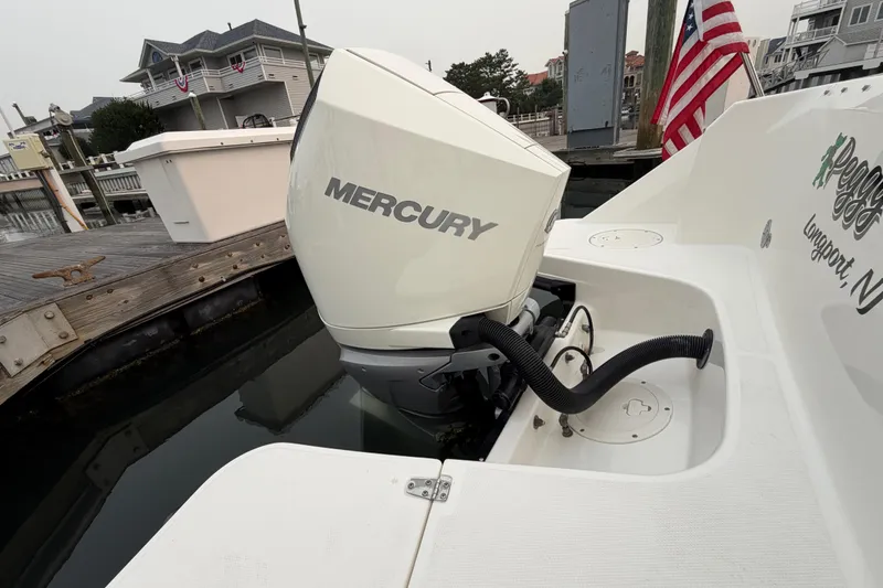 Slide: The Image of 2022 Boston Whaler 240 Vantage with Mercury outboard engine docked at marina. - 53
