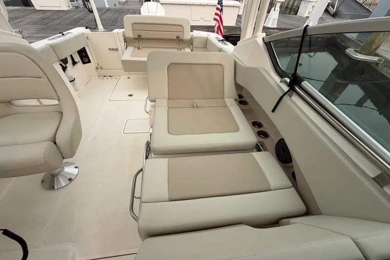 Slide: The Image of 2022 Boston Whaler 240 Vantage interior with beige seating and sleek design. - 40