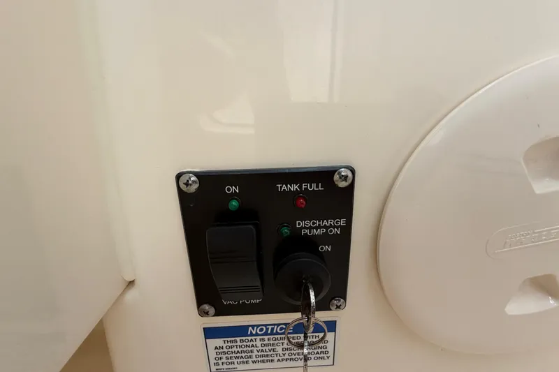 Slide: The Image of Control panel on a 2022 Boston Whaler 240 Vantage boat, showing tank and pump indicators. - 35