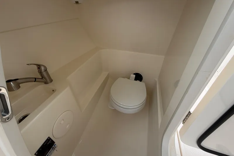 Slide: The Image of Interior of 2022 Boston Whaler 240 Vantage boat bathroom with sink and toilet. - 33