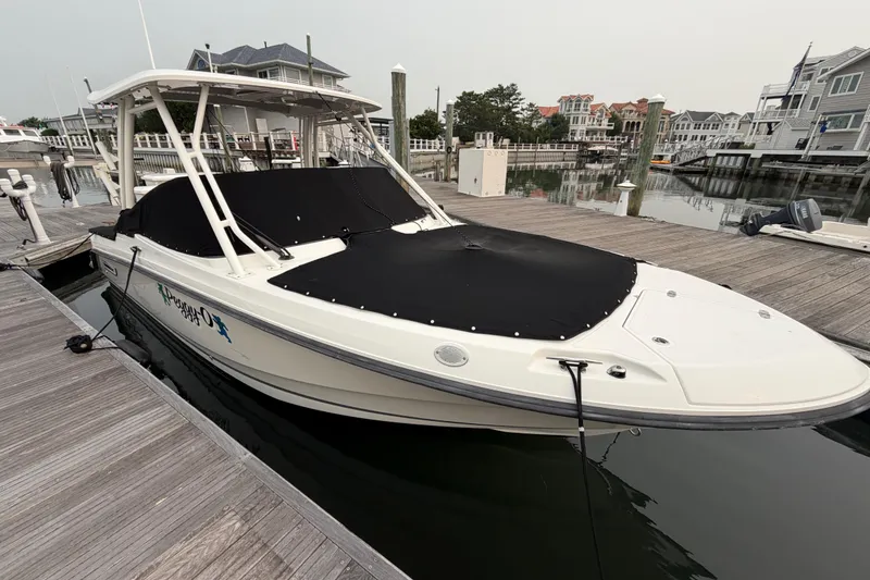 Slide: The Image of 2022 Boston Whaler 240 Vantage boat docked with black cover in marina. - 63