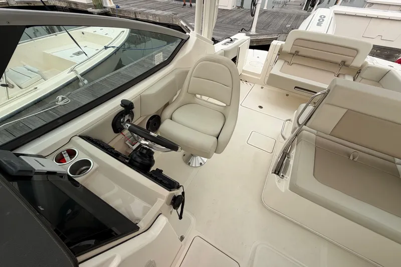Slide: The Image of 2022 Boston Whaler 240 Vantage boat interior with helm, seating, and controls. - 24