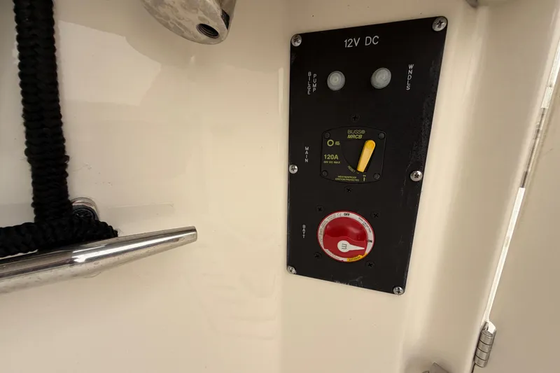 Slide: The Image of Control panel on a 2022 Boston Whaler 240 Vantage boat, featuring 12V DC switches. - 51