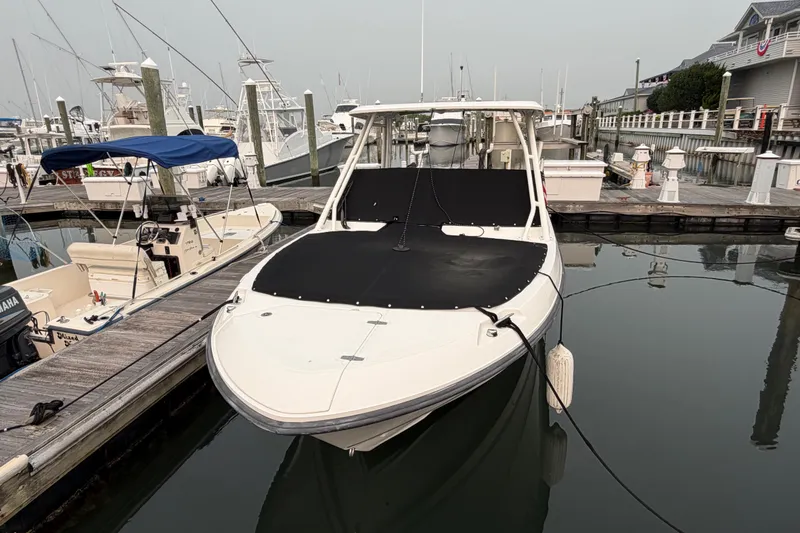 Slide: The Image of Boston Whaler 240 Vantage 2022 docked at marina, covered and ready for adventure. - 59