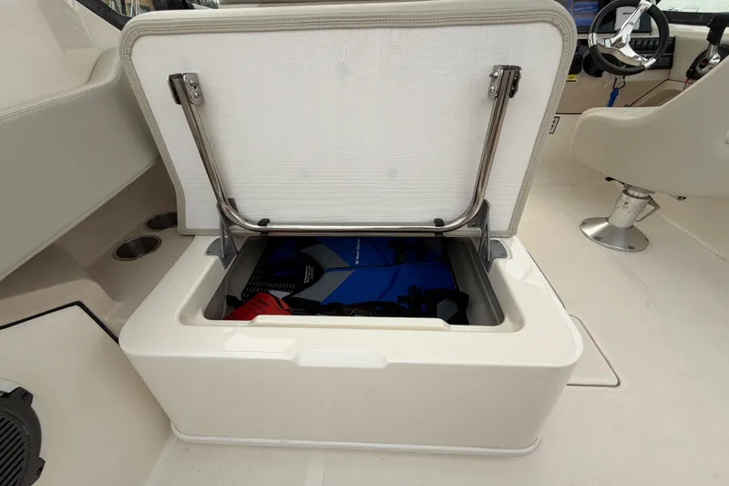 Slide: The Image of 2022 Boston Whaler 240 Vantage boat storage compartment open, revealing interior contents. - 41