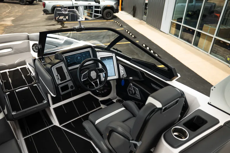 Slide: The Image of 2023 Supra SL 450 boat interior with modern dashboard and sleek seating design. - 26