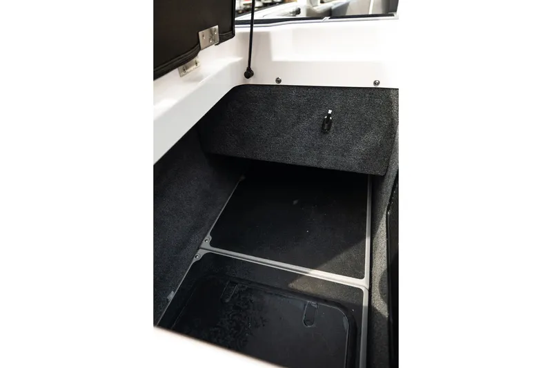 Slide: The Image of 2023 Supra SL 450 storage compartment with carpeted interior and latch. - 38