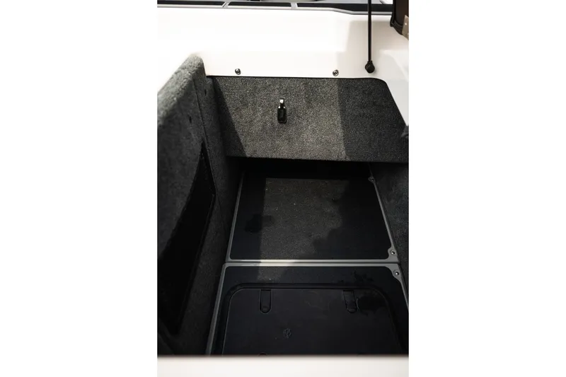 Slide: The Image of Interior view of 2023 Supra SL 450 boat storage compartment with carpeted finish. - 39