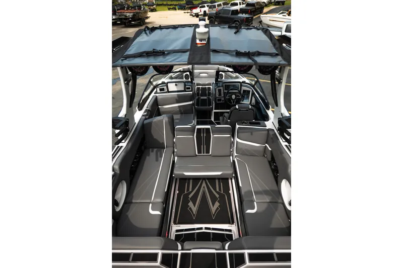 Slide: The Image of 2023 Supra SL 450 boat interior with sleek gray seating and modern dashboard design. - 32