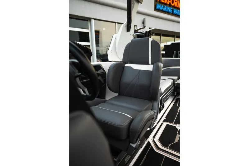 Slide: The Image of 2023 Supra SL 450 boat interior with sleek black and white seating. - 18