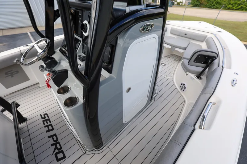 Slide: The Image of 2020 Sea Pro 239 Center Console boat interior with steering wheel and seating area. - 13