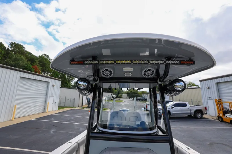 Slide: The Image of 2020 Sea Pro 239 Center Console boat with T-top and speakers in a parking lot. - 18