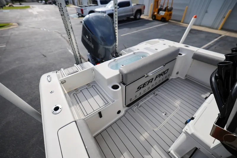 Slide: The Image of 2020 Sea Pro 239 Center Console boat interior with Yamaha engine, docked in a parking area. - 7