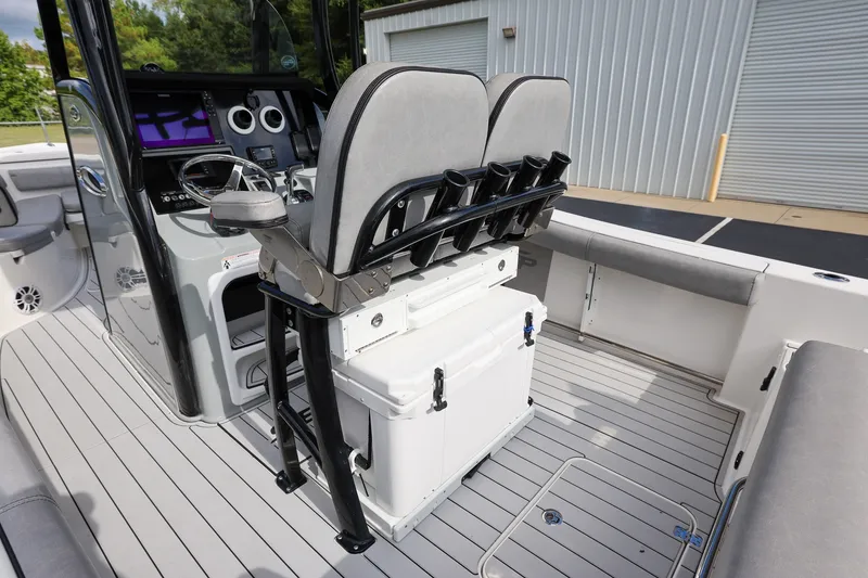 Slide: The Image of 2020 Sea Pro 239 Center Console boat interior with helm, seating, and rod holders. - 9