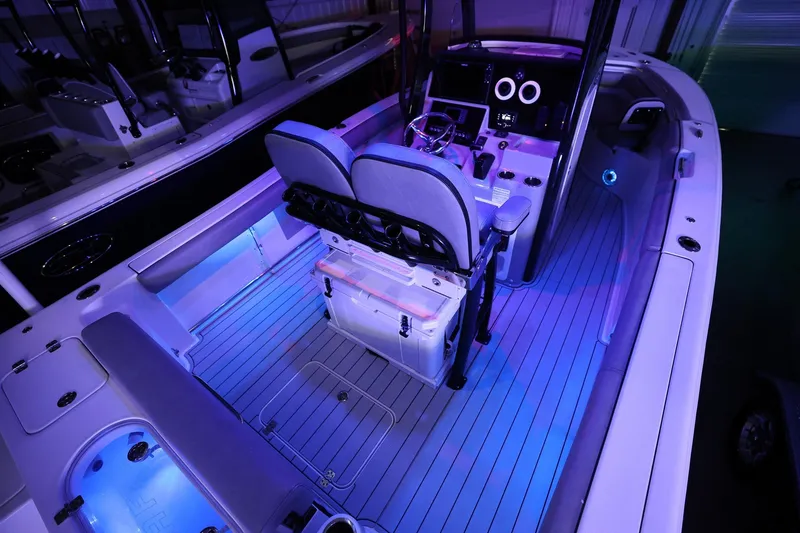 Slide: The Image of 2020 Sea Pro 239 Center Console boat interior with illuminated seating and modern controls. - 25