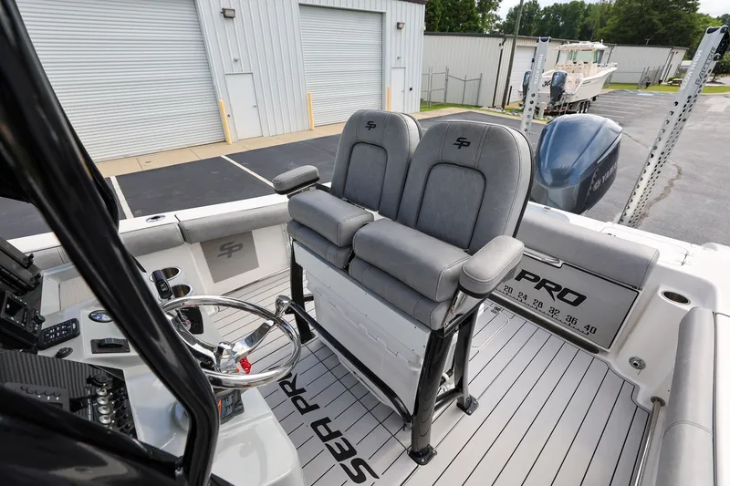 Slide: The Image of 2020 Sea Pro 239 Center Console boat interior with dual seats and steering wheel. - 11