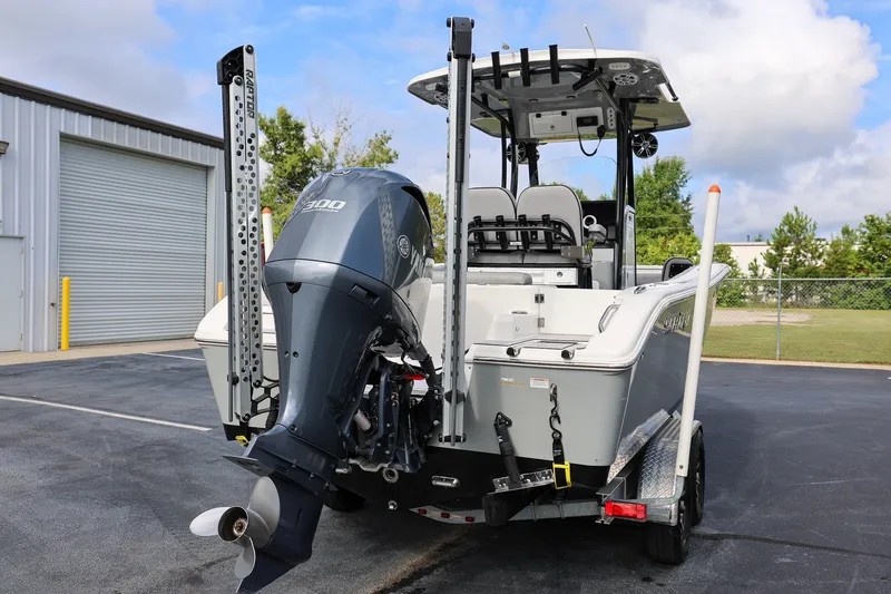 Slide: The Image of 2020 Sea Pro 239 Center Console boat with powerful outboard motor, parked outdoors. - 2