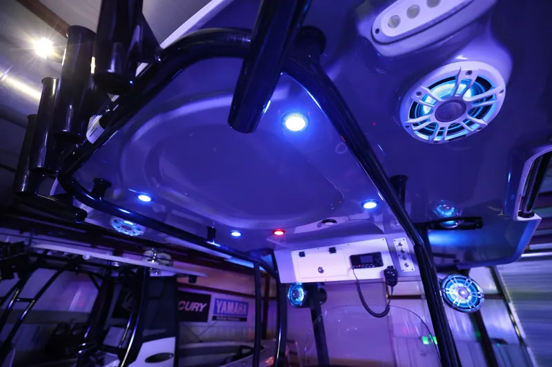 Slide: The Image of 2020 Sea Pro 239 Center Console boat interior with blue LED lighting and speakers. - 26