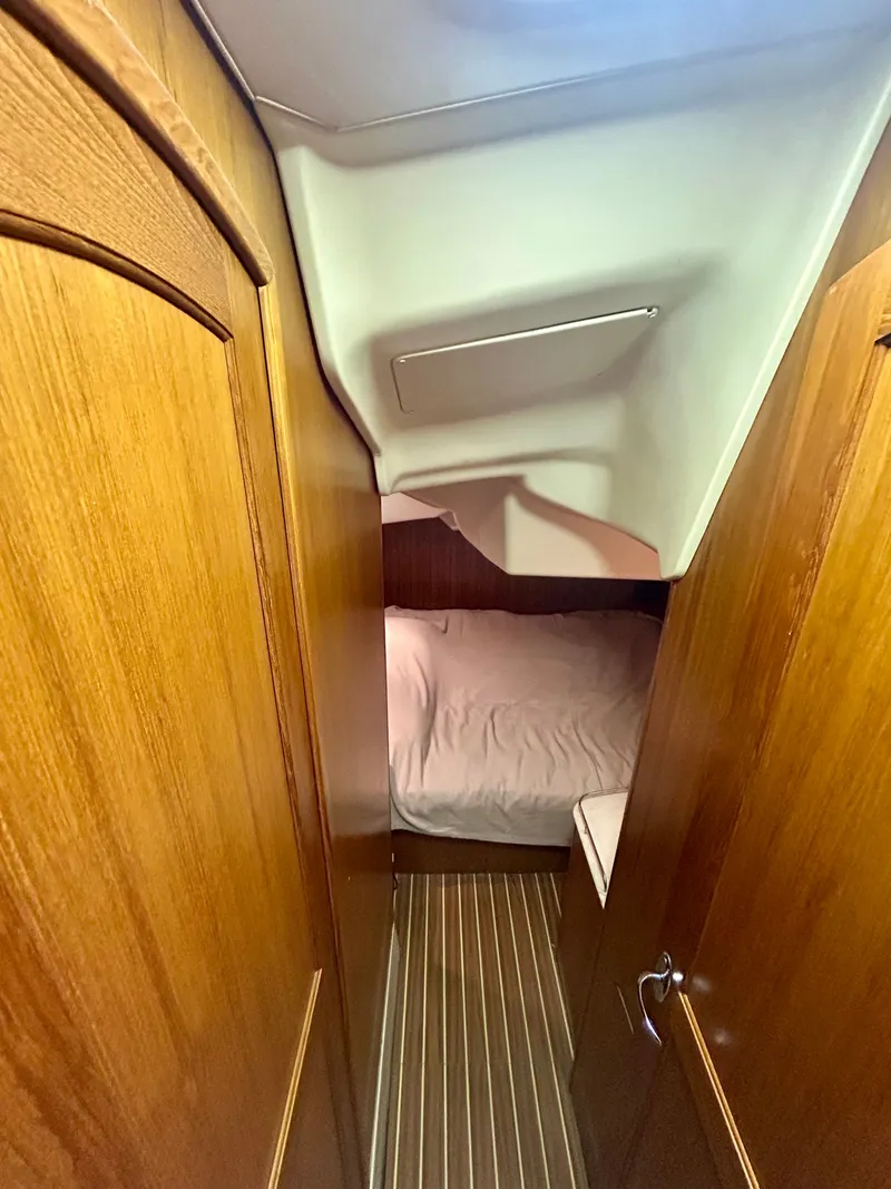 Slide: The Image of Interior of a 2005 Hunter 41 Aft Cockpit with wooden walls and a bed. - 9
