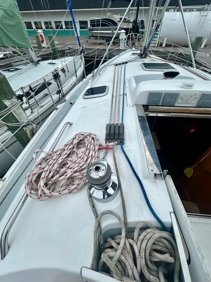 Slide: The Image of The image shows the deck of a 2005 Hunter 41 Aft Cockpit sailboat with ropes and winches. - 28